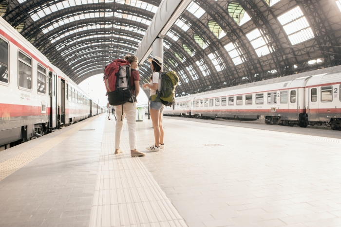 Two girls waiting for their train at the train station