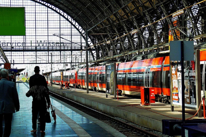 Train station with people waiting for their trains