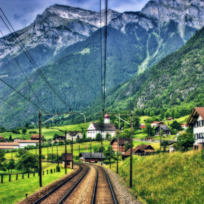 Rails in the background of huge and beautiful mountains