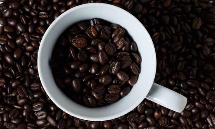 a mug filled with coffee beans