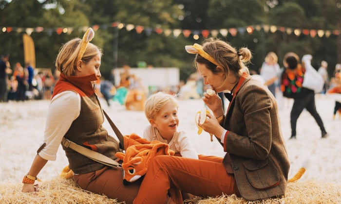 two women with a child at a festival