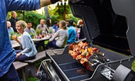 man opening a barbecue grill