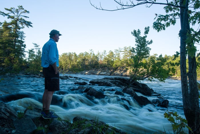 man on a river shore