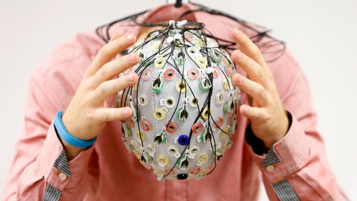 Man with helmet on his head full of wires and diodes