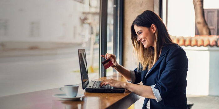 Happy woman shopping online with her credit card