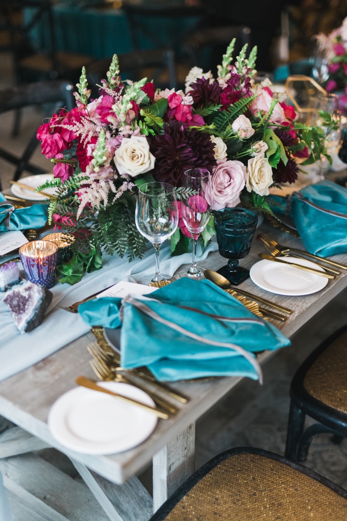 Fall wedding table with jewel tones flowers and golden cutlery