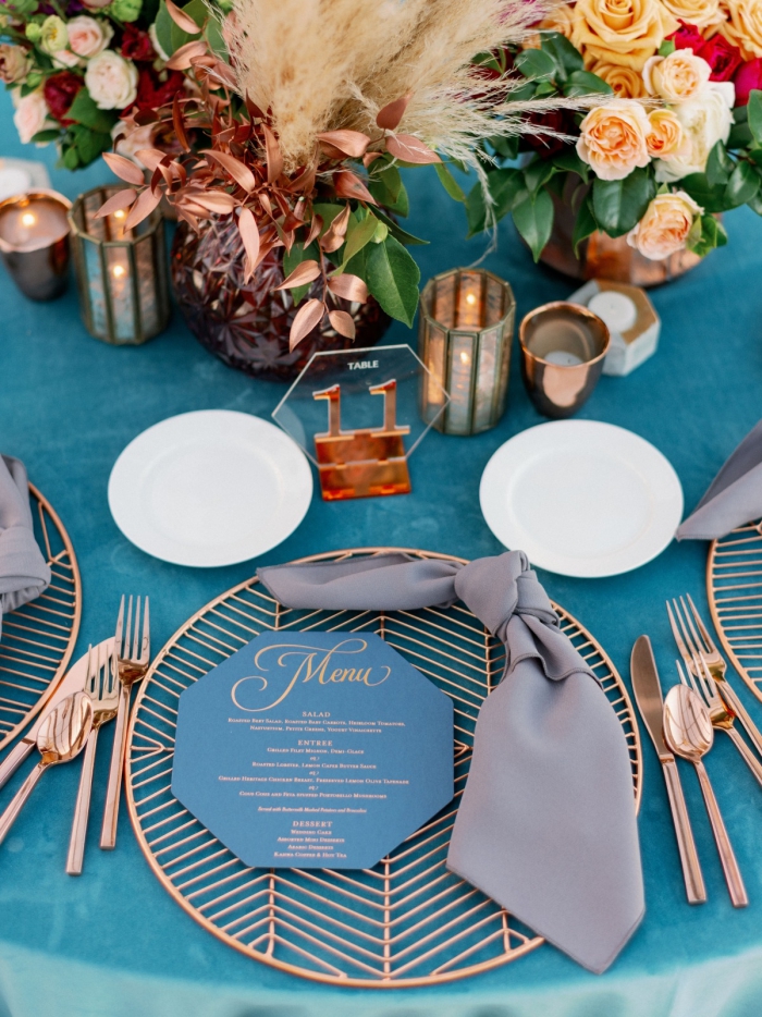 beautiful elegant wedding table decoration in gold and blue flower arrangements