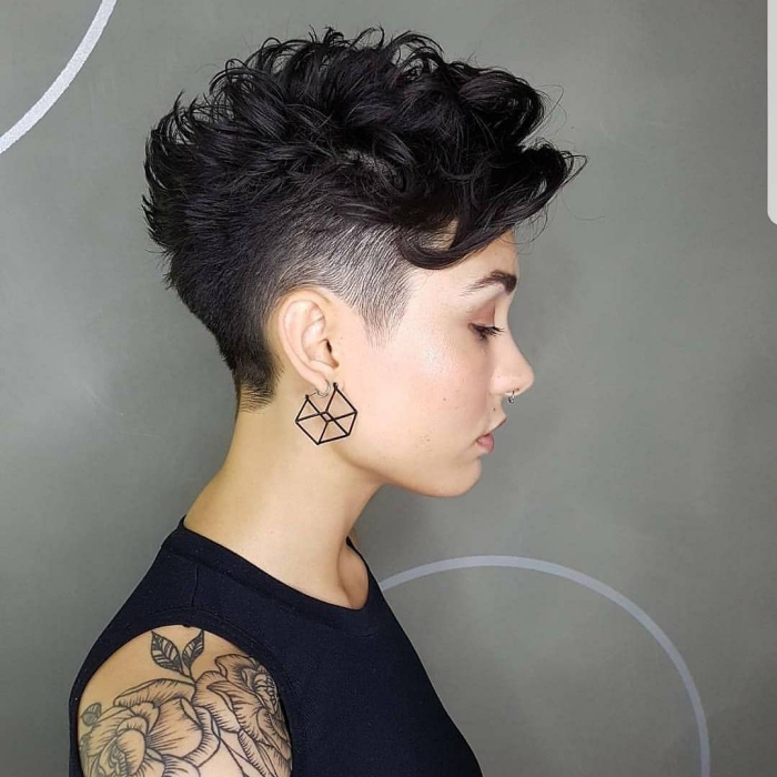 woman profile black top artistic earrings and curly undercut pixie