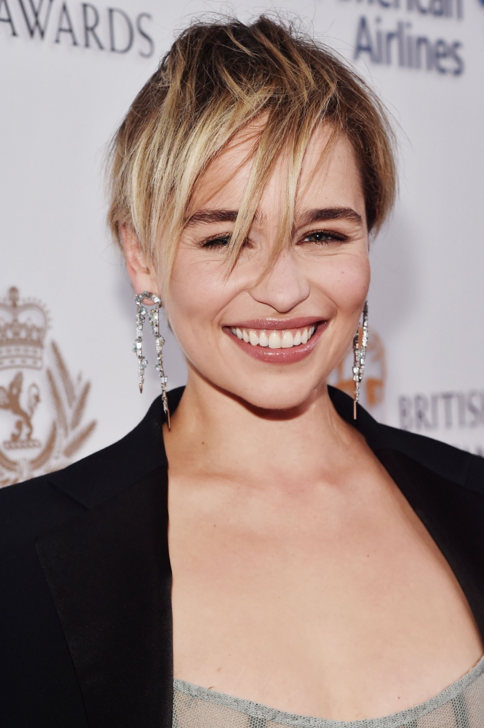 celebrity smiling on the red carpet short pixie hair long earrings black top