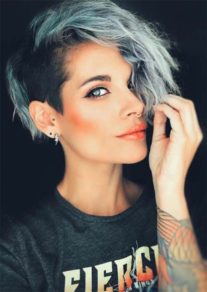 woman with light eyes short green pixie haircut