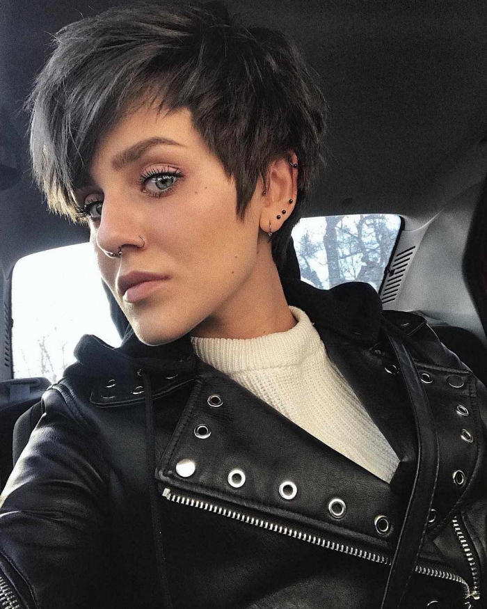 Woman in car with leather jacket and short pixie hair