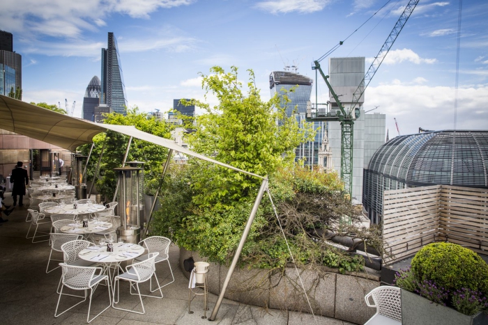 Coq d’Argent rooftop restaurant terrace with white tables overlooking the city
