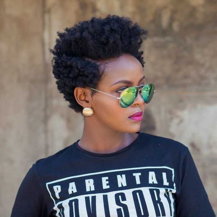 Woman with short curly hair and sunglasses outdoors