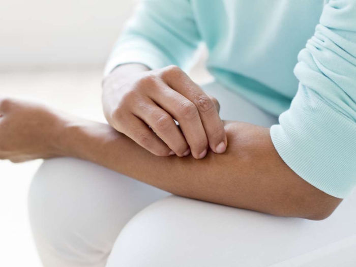 Person scratching his skin with fungal infection