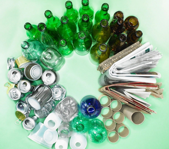 circle made of different items glass bottles cans paper plastic