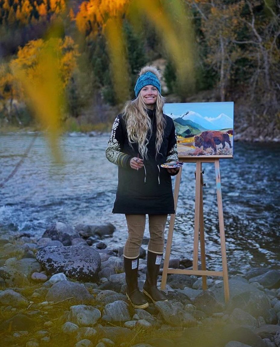 Rachel Pohl painting outdoors on a river bank