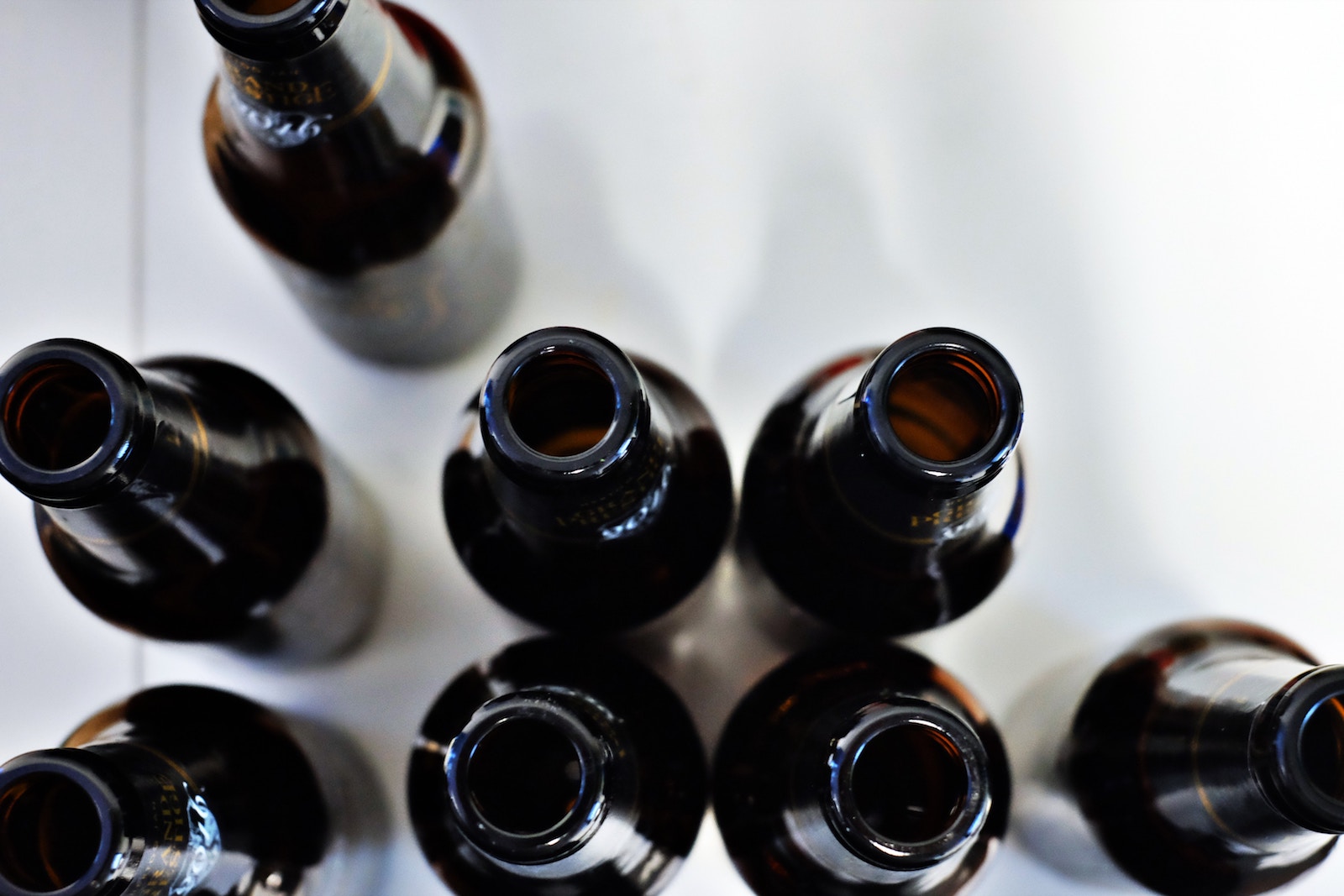 close up dark beer bottles from above