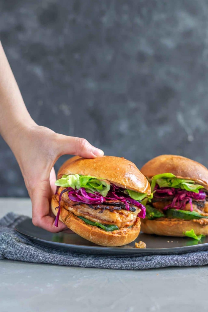 hand grabbing one of two Mexican tortas