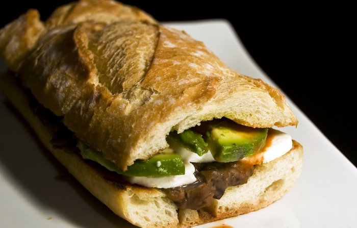 Mexican sandwich  with meat and avocado close up