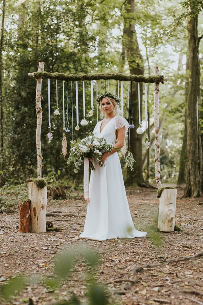 Outdoor bohemian wedding bride with forest in the backdrop