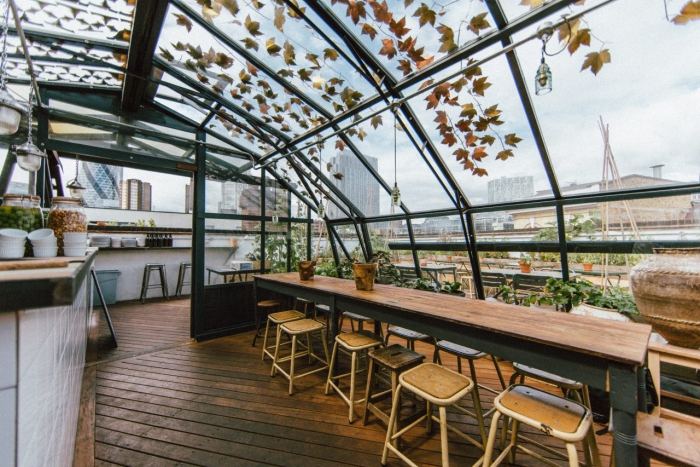 Rooftop restaurant interior glass roof and bar