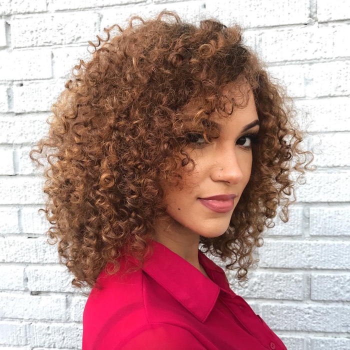 Woman dressed in bright shirt with curly hair