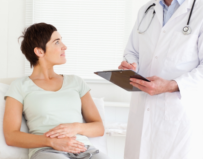 Woman with yeast infection looking at doctor