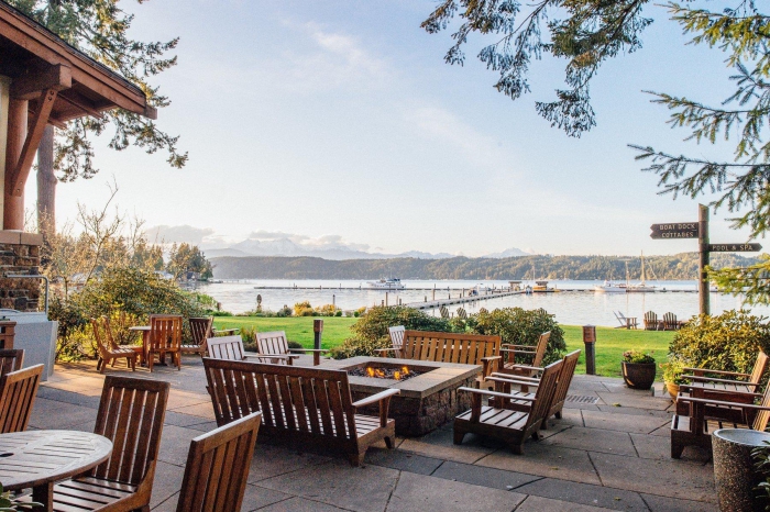 large terrace with wooden furniture and fire pits beautiful view on lake