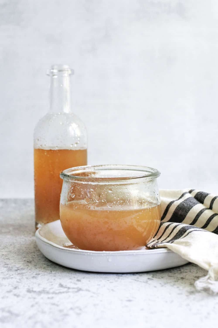 Apple Cider Vinegar in a glass bottle and in a jar 