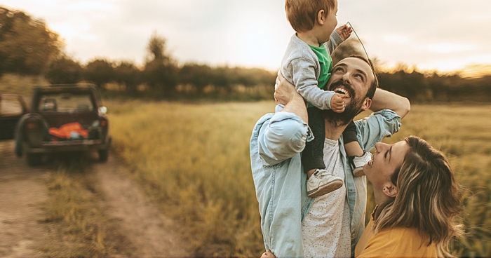 Autumn family outdoor activities ideas family of three in the field laughing