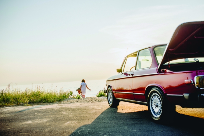 Autumn road trip red retro car woman with a picnic basket