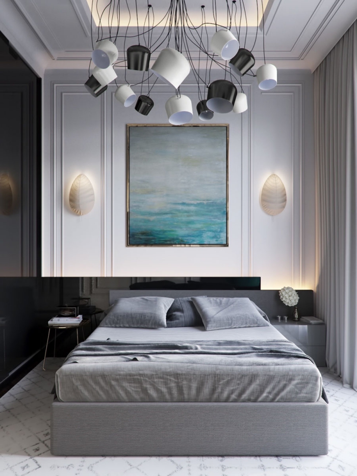 Grey and white modern bedroom with dramatic lighting fixtures and large painting