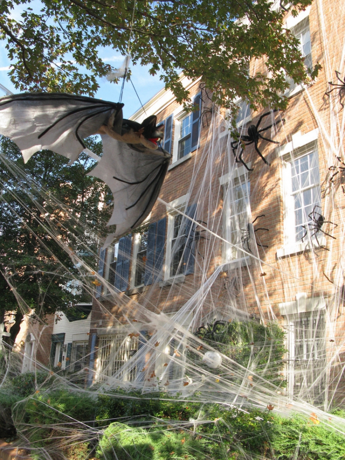 Huge outdoor Halloween spider web with spiders and bats