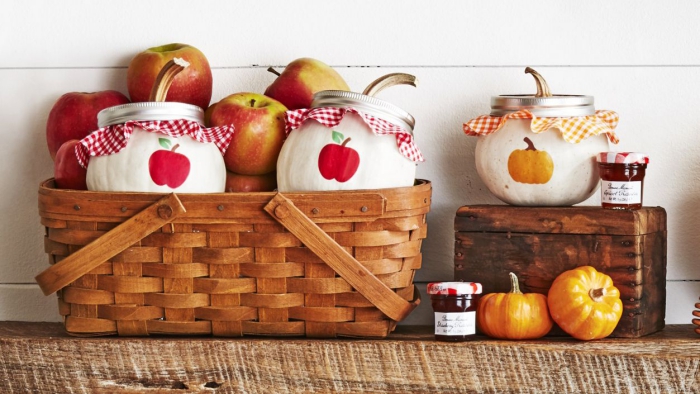 Baskets with apples and pumpkins and fall themed decorated jars