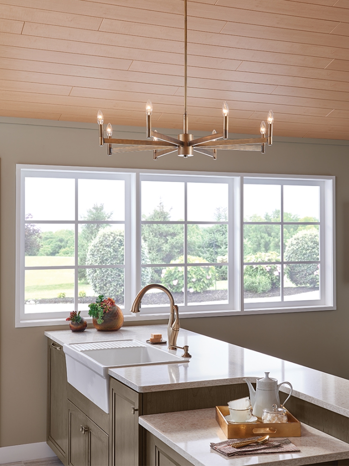 Sleek modern metallic gold kitchen chandelier in a minimalist kitchen interior