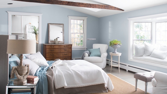 light spacious and airy master bedroom in light blue and crisp white interior colors