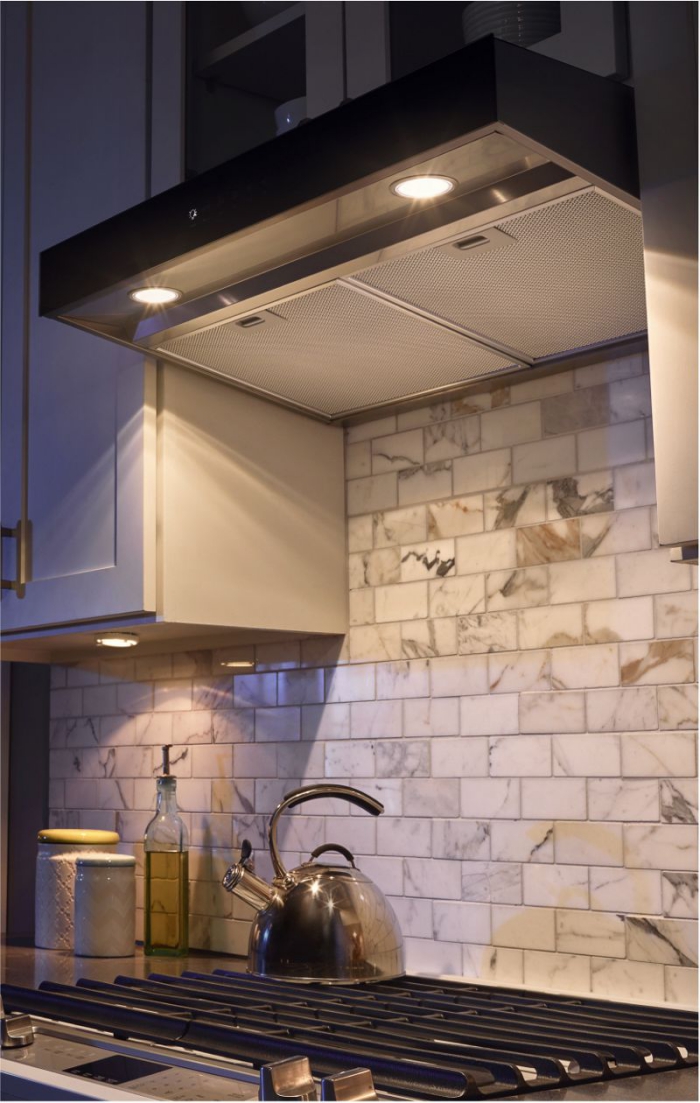 Stove hood lighting bright spot lights brick backsplash wall