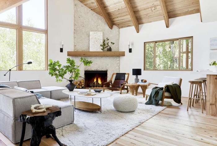 Modern living room in Scandinavian style with wooden ceiling and floor, fireplace and soft carpet