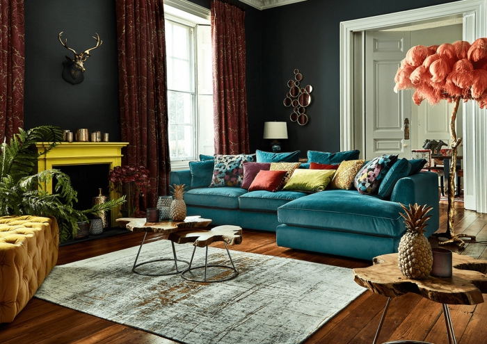 modern eclectic living room with dark walls and colorful accents bright yellow fireplace and turquoise sofa 