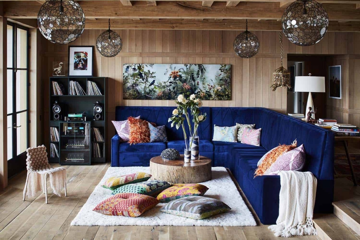 modern living room with wooden walls and floor and dark blue sofa