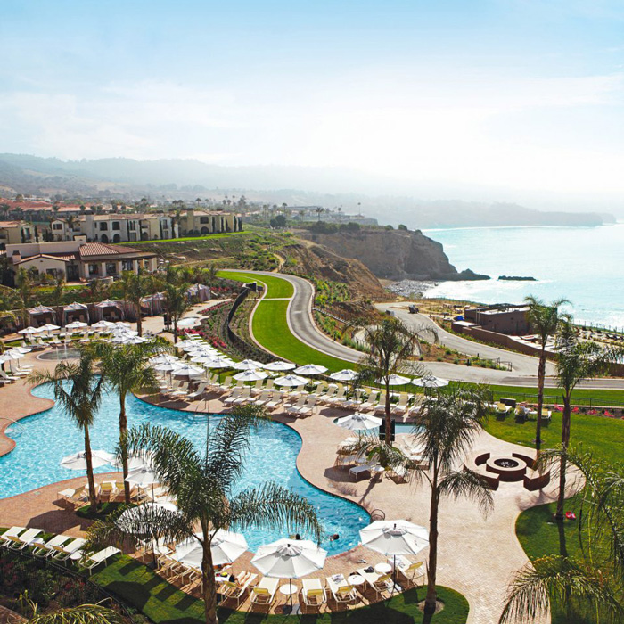 Terranea Resort in California outdoor sea view with palm trees and a pool