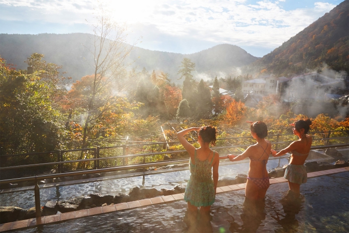 Yunessun Spa Resort Japan exotic spa treatments three women in hot water terrace with view over a forest