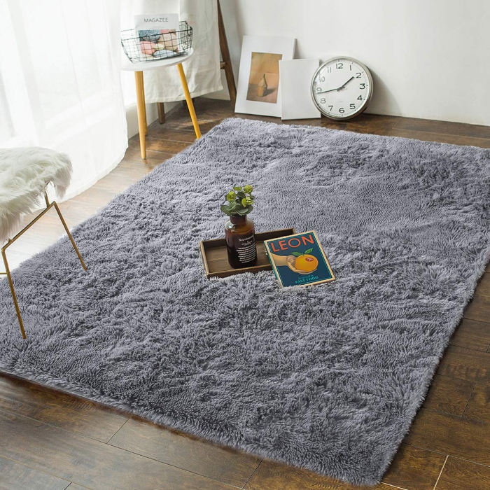 soft comfortable grey bedroom rug on a wooden floor