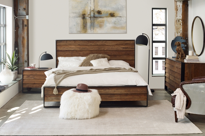 modern bedroom with wooden bed and furniture soft ottoman and abstractart