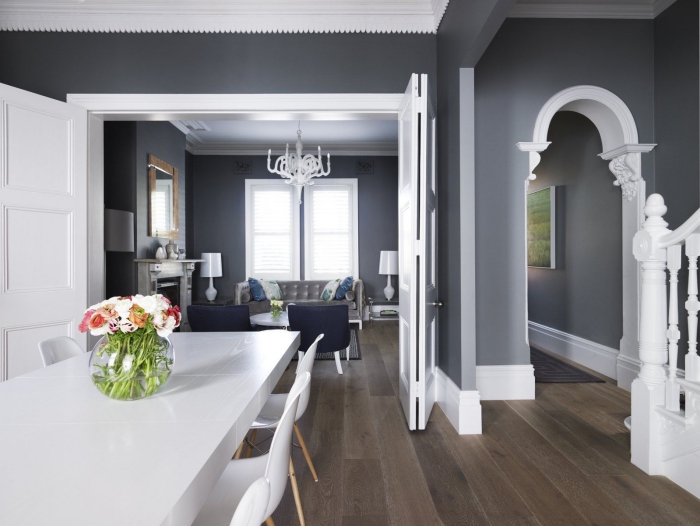 Elegant traditional dining and living area in dark grey and contrasting white