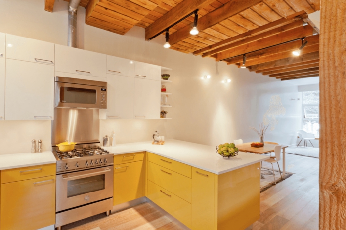 simple elegant light small kitchen with white and yellow cabinets and wooden ceiling