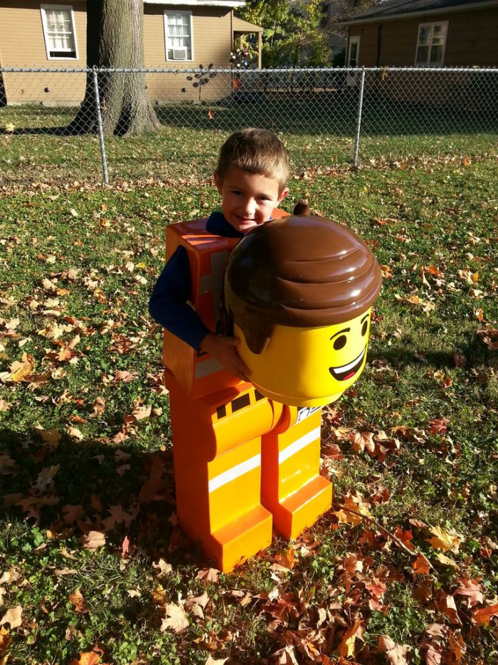 Little boy with a LEGO Halloween costume in a yard