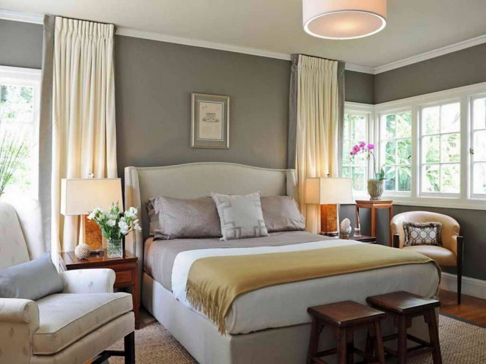 elegant master bedroom in shades of grey and pops of beige and yellow tones