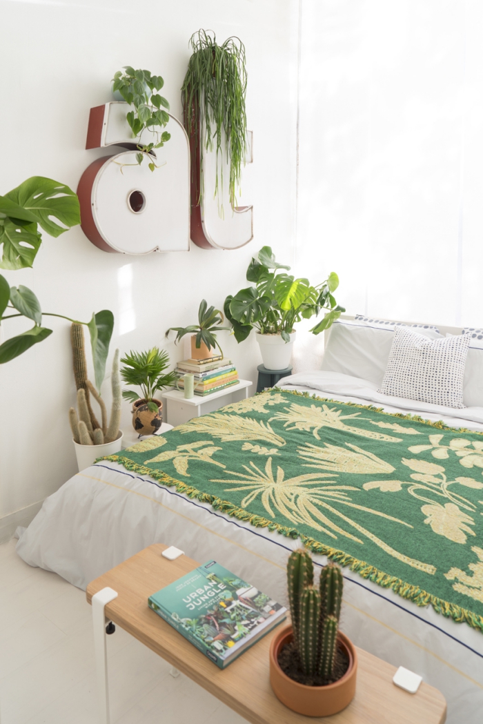 green potted plants in a white bedroom