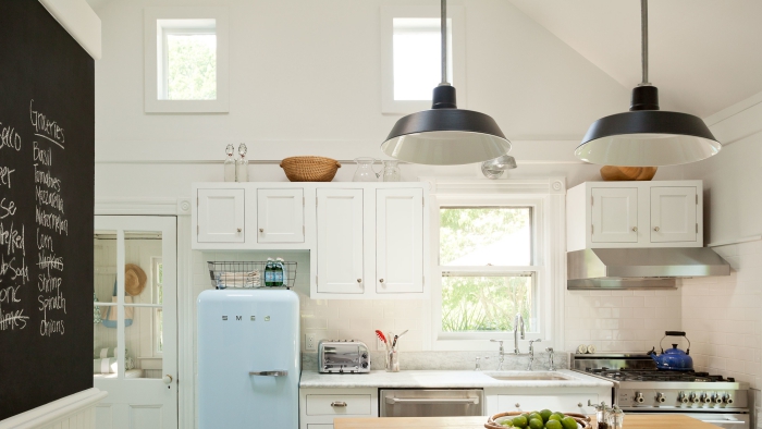 white kitchen with chalkboard wall and retro light blue fridge